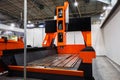 Large orange and black CNC machine in an industrial setting. Modern manufacturing technology for precision machining Royalty Free Stock Photo