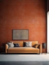 Large, orange couch in an empty room with braun walls. A small table is placed next to couch, and there are two chairs