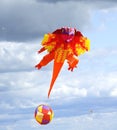 Large orange Dragon kite flying high