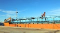 Large orange empty barge cargo ship standing at the pier