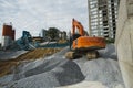 Large orange excavator working on a gravel on construction site. Details of industrial excavator. Big excavator standing Royalty Free Stock Photo