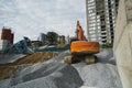 Large orange excavator working on a gravel on construction site. Details of industrial excavator. Big excavator standing Royalty Free Stock Photo