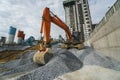 Large orange excavator working on a gravel on construction site. Details of industrial excavator. Big excavator standing Royalty Free Stock Photo