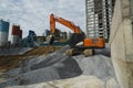 Large orange excavator working on a gravel on construction site. Details of industrial excavator. Big excavator standing Royalty Free Stock Photo