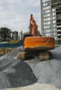 Large orange excavator working on a gravel on construction site. Details of industrial excavator. Big excavator standing Royalty Free Stock Photo