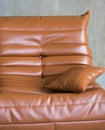 a large orange leather armchair stands on the floor Royalty Free Stock Photo