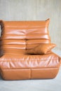 a large orange leather armchair stands on the floor Royalty Free Stock Photo