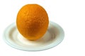 A large orange on a plate on a white background
