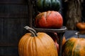 A large orange pumpkin stands on the white and black keys of an old piano next to dry ears of yellow corn. Royalty Free Stock Photo