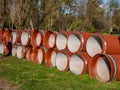 Large orange sewer pipes lie on the ground in two rows