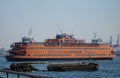 Large orange Staten Island ferry boat docked near a body of water in New York, USA. Royalty Free Stock Photo