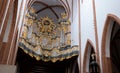 Large ornate gold accented pipe organ in the interior of St. Elizabeths Church in Wroclaw, Poland. Sacral music religious catholic