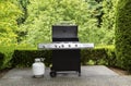 Large outdoor bbq cooker with lid in open position on home concrete patio Royalty Free Stock Photo