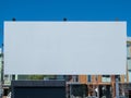 Large outdoor blank canvas movie screen displayed in a city park