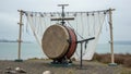 Large outdoor drum display by the sea on a cloudy day Royalty Free Stock Photo