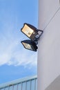 Large outdoor light on blue sky vertical