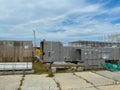 A large outdoor warehouse at a construction site, a warehouse for industrial equipment and materials in boxes at an open-air Royalty Free Stock Photo