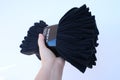 large pack of new men's black socks in female hand, concept gift for the day father, socks are lost, practical purchase, new