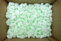 Large packaging box filled with many white styrofoam pellets Royalty Free Stock Photo