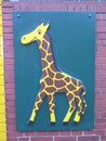 Large painting of happy giraffe on school wall