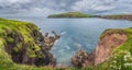 Large panorama with Dingle Lighthouse and bay surrounded by cliffs Royalty Free Stock Photo