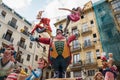 Large paper mache sculpture of circus director between traditional old town houses for the national festival Fallas in Valencia,