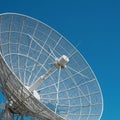 Large parabolic satellite dish against a clear blue sky. The dish is composed of a Royalty Free Stock Photo