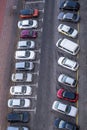 large parking lot for cars in front of a multi-storey residential building view from above