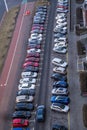 large parking lot for cars in front of a multi-storey residential building view from above