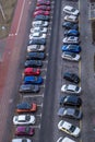 large parking lot for cars in front of a multi-storey residential building view from above