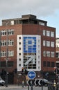 Large parking sign on a building on the corner of Lady Lane in Leeds with traffic and road signs