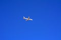 A large passenger plane flies high in the blue sky. Vacation, tr Royalty Free Stock Photo