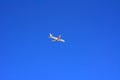 A large passenger plane flies high in the blue sky. Vacation, tr Royalty Free Stock Photo