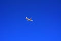 A large passenger plane flies high in the blue sky. Vacation, tr Royalty Free Stock Photo