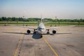 A large passenger plane stands at the airfield, front view of the cockpit. The aircraft is parked near the terminal. The plane Royalty Free Stock Photo