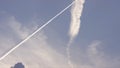 Large passenger supersonic plane flying high in clear blue sky, leaving long white trail. Airplanes leaving diagonal