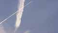 Large passenger supersonic plane flying high in clear blue sky, leaving long white trail. Airplanes leaving diagonal Royalty Free Stock Photo