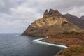 large pebble mountain by the calm sea in an arid environment of the canary islands under cloudy skies Royalty Free Stock Photo