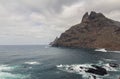 large pebble mountain by the calm sea in an arid environment of the canary islands under cloudy skies Royalty Free Stock Photo