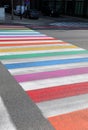 large pedestrian crossing with lines of many rainbow colors in t