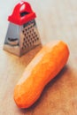 Large peeled carrots and a small grater