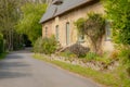 Large, picturesque detached cottage seen in a rural location.