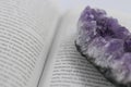 A large piece of Amethyst on an open book