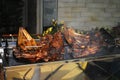 Large piece of beef rib roasted on the roller. Meat barbecue for many people. Roasted beef. Steak on the bone Royalty Free Stock Photo