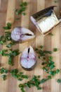 Large piece bloater and green onion on the board Royalty Free Stock Photo