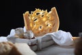 A large piece of hard maasdam cheese on a black background. Cheese with lots of holes. Dutch Maasdamer cheese in a white wooden Royalty Free Stock Photo