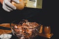 A large piece of pork is cut into pieces, marinated by the chef with spices, and the chef rubs the potatoes on a grater to the Royalty Free Stock Photo