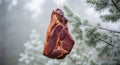 Smoked Meat Hanging in Winter Forest with Pine Branches Covered by Snow Royalty Free Stock Photo