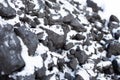 large pieces of coal under the snow. Fuel for the stove in winter. Heating a house in the countryside Royalty Free Stock Photo