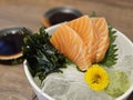 Large pieces of fresh Salmon sashimi with wagame seaweed serving on ice cube with wasabi ball Royalty Free Stock Photo